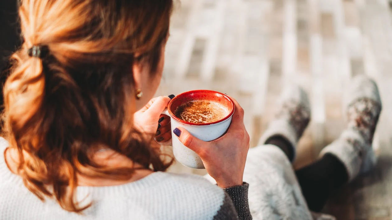A woman drinking a cup of coffee