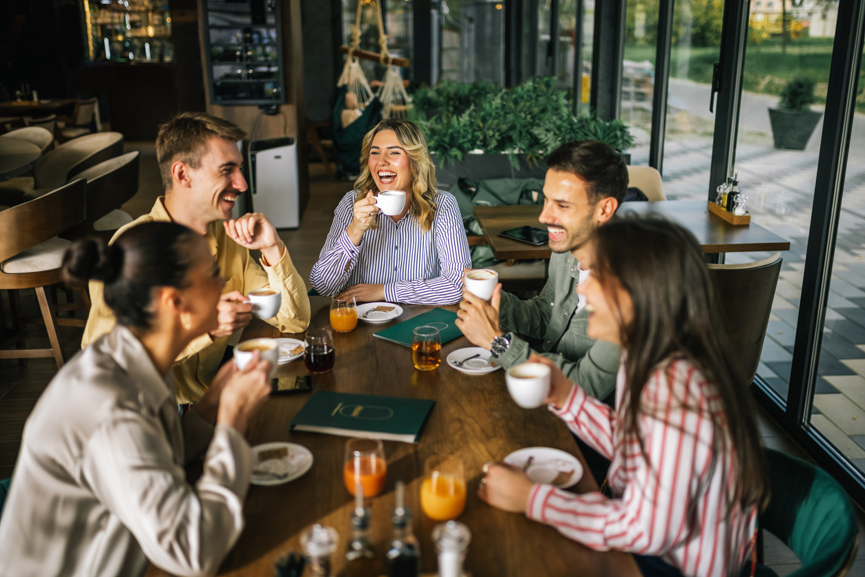 friends drinking coffee and juices at a café together