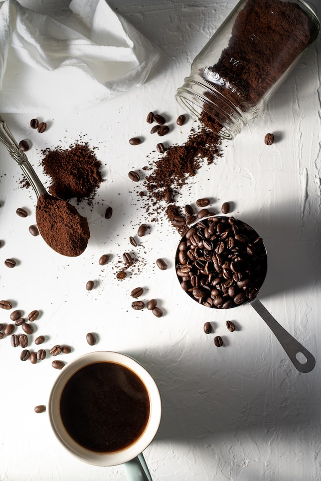 coffee beans and a cup of coffee on a table