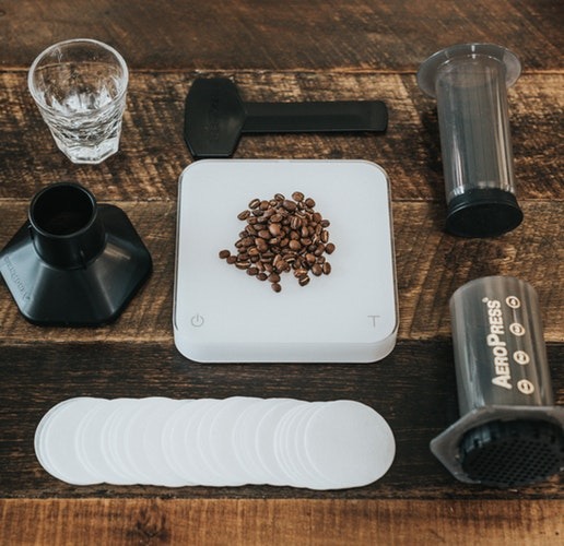 Coffee beans and an AeoPress brewer