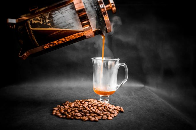 French press coffee being poured in a glass