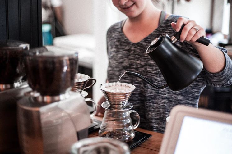 woman doing the pour-over coffee brewing method
