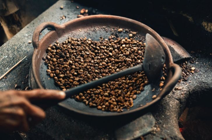 An image showing coffee beans getting roasted.