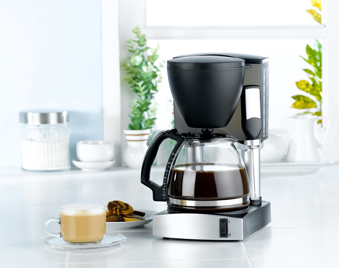 Coffee maker and a cup of coffee