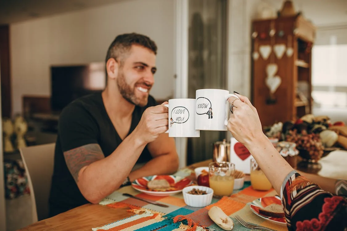 two people enjoying coffee on a dinner table